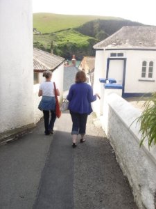 two women walking down the hill in Port Issac