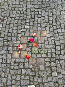 bronze placques on cobbled ground with roses.